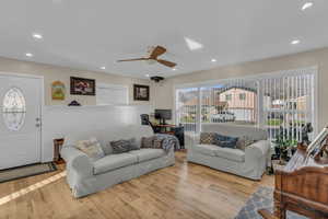 Living room with an office area, recessed lighting, wood finished floors, and ceiling fan