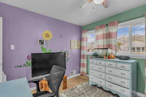 Office space with light wood finished floors and baseboards