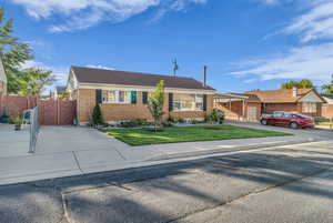 Ranch-style home with brick siding and a front lawn