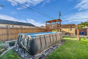 View of swimming pool with a fenced backyard, a patio, and a playground