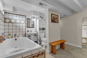 Full bath featuring a bath and light tile patterned floors