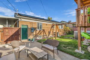 View of patio / terrace featuring a playground and a gate