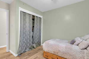 Bedroom featuring light wood-style flooring and baseboards