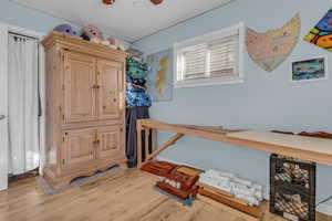Bedroom featuring light wood finished floors and ceiling fan
