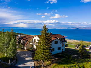 Aerial view of property and surrounding area featuring a nearby body of water