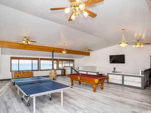 Recreation room featuring wood finished floors, vaulted ceiling, billiards table, and a ceiling fan