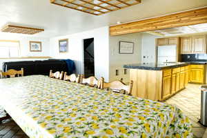 Dining area featuring brick flooring and stairs
