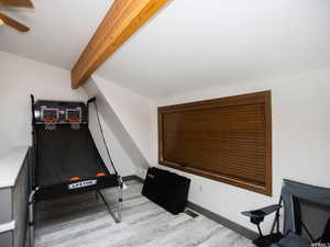 Game room with light wood-type flooring and baseboards