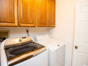 Washroom with cabinet space and separate washer and dryer