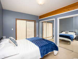 Bedroom featuring carpet flooring and two closets