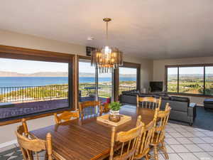 Dining room featuring tile patterned floors and a chandelier