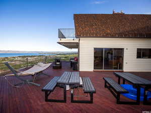 Deck featuring outdoor dining area, a water view, and area for grilling