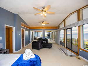 Carpeted bedroom with ceiling fan, access to outside, and lofted ceiling
