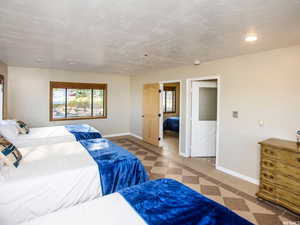 Bedroom with recessed lighting and a textured ceiling