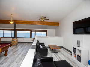 Living area with pool table, light wood finished floors, and ceiling fan