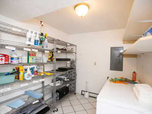 Laundry area featuring light tile patterned floors and electric panel