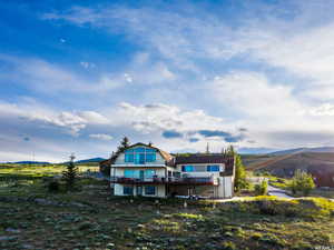 Back of property featuring a mountain view