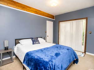 Bedroom featuring light colored carpet and baseboards