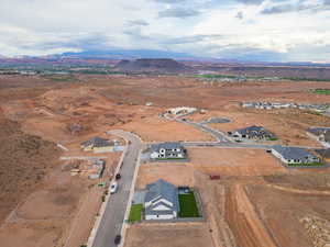 Aerial view of property and surrounding area with mountains, nearby suburban area, and rural landscape