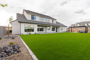 Back of property with a patio, stucco siding, a fenced backyard, and a tiled roof