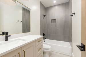 Full bath with vanity, washtub / shower combination, and light tile patterned floors