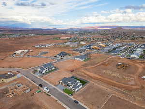 Aerial overview of property's location with nearby suburban area and mountains