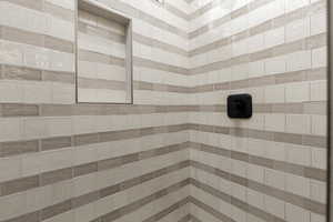 Bathroom featuring tiled shower