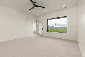 Empty room featuring carpet, recessed lighting, and ceiling fan