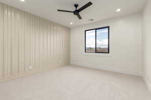Empty room with light colored carpet, recessed lighting, and a ceiling fan
