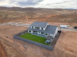 Aerial view of property and surrounding area featuring mountains