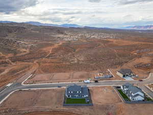 Aerial view of sparsely populated area with mountains and a desert landscape