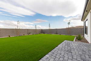 Fenced backyard featuring a patio