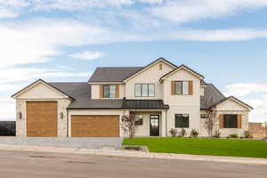 Modern farmhouse featuring a front lawn, decorative driveway, board and batten siding, an attached garage, and a metal roof