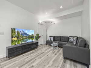 Living area featuring light wood finished floors and recessed lighting