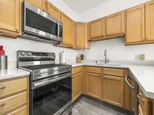 Kitchen with appliances with stainless steel finishes and light wood finished floors