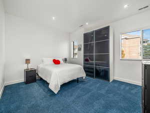 Bedroom featuring recessed lighting and dark carpet
