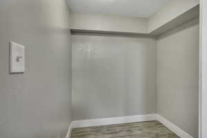 Walk in closet with light wood-style flooring