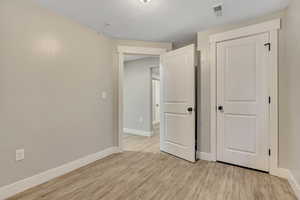 Unfurnished bedroom featuring baseboards and light wood finished floors
