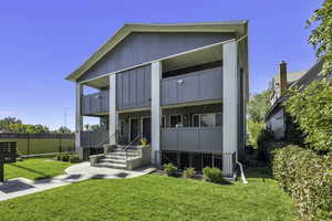 View of front facade featuring a balcony and brick siding