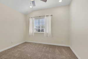 Spare room with carpet, lofted ceiling, a ceiling fan, recessed lighting, and a textured ceiling