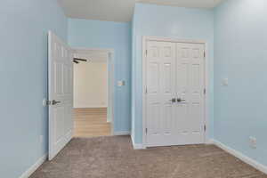 Unfurnished bedroom featuring carpet floors and a closet