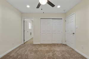 Unfurnished bedroom featuring light colored carpet, recessed lighting, a closet, and ceiling fan