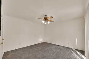 Unfurnished room with carpet flooring and a ceiling fan
