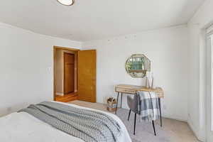 Bedroom with ornamental molding and carpet flooring