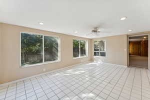 Empty room featuring light tile patterned floors, ceiling fan, and recessed lighting