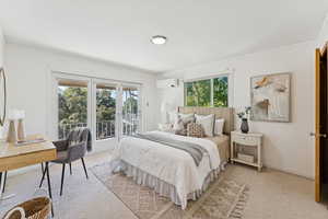 Bedroom featuring carpet floors, ornamental molding, access to outside, and a wall mounted AC