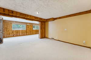 Carpeted empty room featuring a textured ceiling and recessed lighting