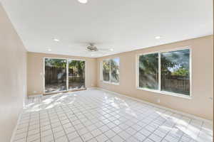 Empty room with light tile patterned flooring, a ceiling fan, and recessed lighting