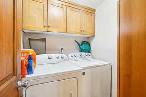 Laundry room with cabinet space and washing machine and clothes dryer