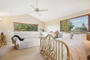 Bedroom featuring vaulted ceiling, carpet flooring, and a ceiling fan